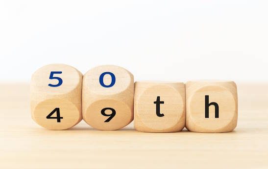 turning-50-years-old-concept-text-on-wooden-blocks-and-changing-dices